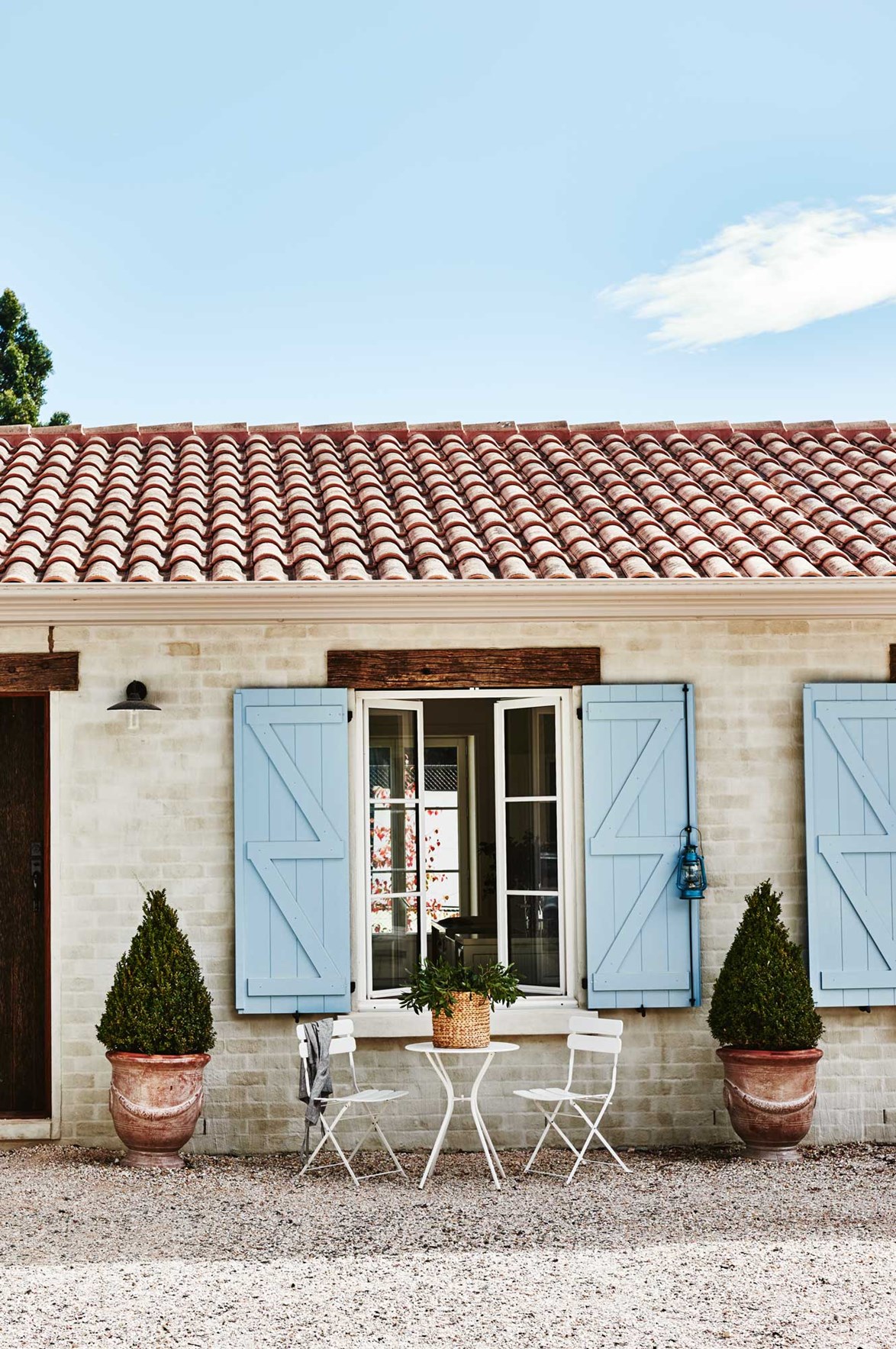 Determined to recreate the look of a French farmhouse, Narelle and Andrew quickly settled on their choice of blue window shutters.