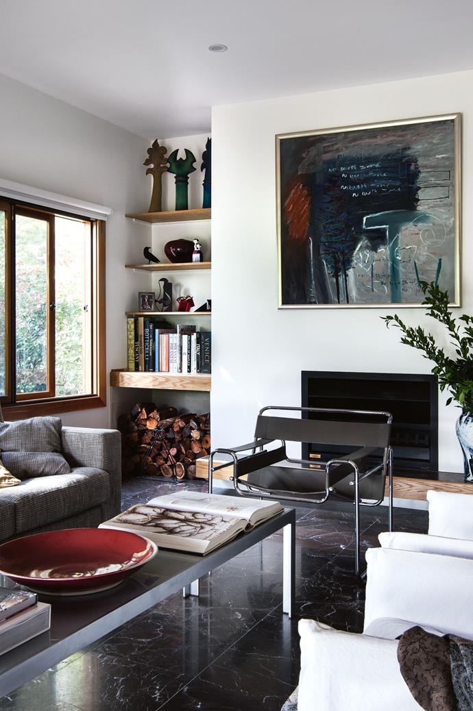 In the living room, a painting by Wendy Stokes overlooks a Monica Armani coffee table. The room is laid with Morato Etrusco honed marble flooring from Artedomus.