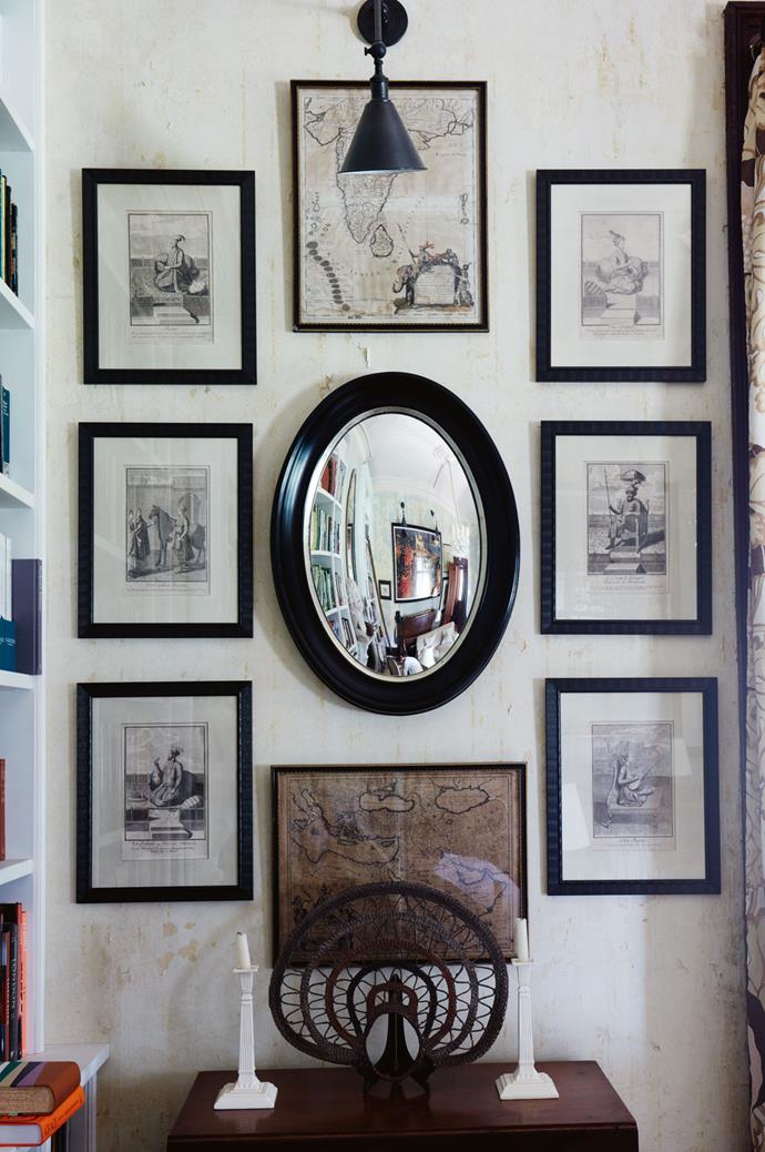 The library is home to countless [pieces the couple have collected on their travels](https://www.homestolove.com.au/8-interior-trends-from-around-the-globe-6715|target="_blank") over the years. Here, arranged around a custom oval convex mirror, are early 17th-century maps of India and The Holy Land, as well as six 17th-century French engravings of maharajas from the Roger Banks-Pye collection. On the table is a wedding headpiece from the Wosera district in Papua New Guinea.