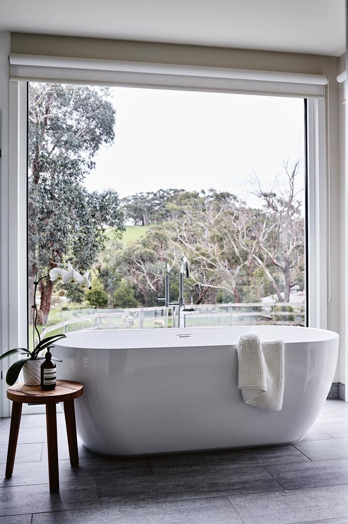 The 'Olsen' tub from [Schots Home Emporium](https://www.schots.com.autakes|target="_blank"|rel="nofollow") takes centre stage in the main bathroom, which boasts views of the paddocks.