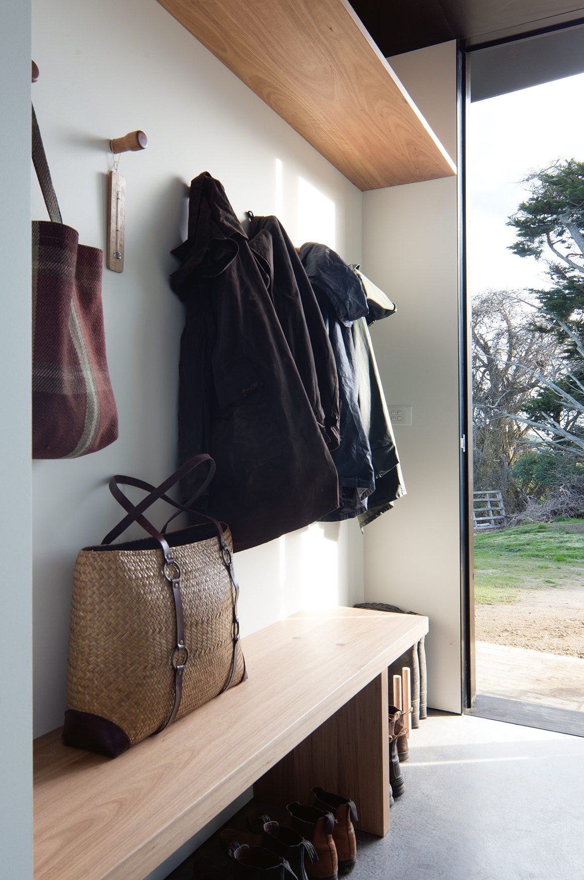 High storage, wall storage and under-bench storage is the perfect mix in this minimalist mudroom design.