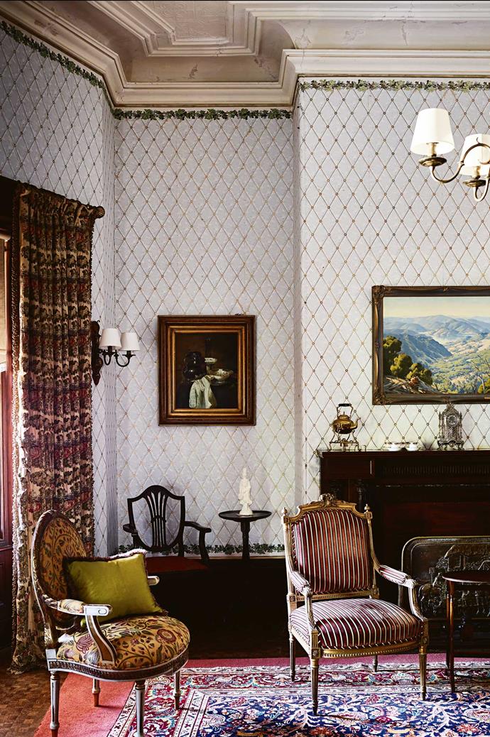 The drawing room still has original wallpaper and heavy curtains woven with silver thread. "There are thousands of pure silver threads running the entire length of the curtains, and we've had a quote for restoring them, and we're looking down the barrel of $100,000," says Andrew.