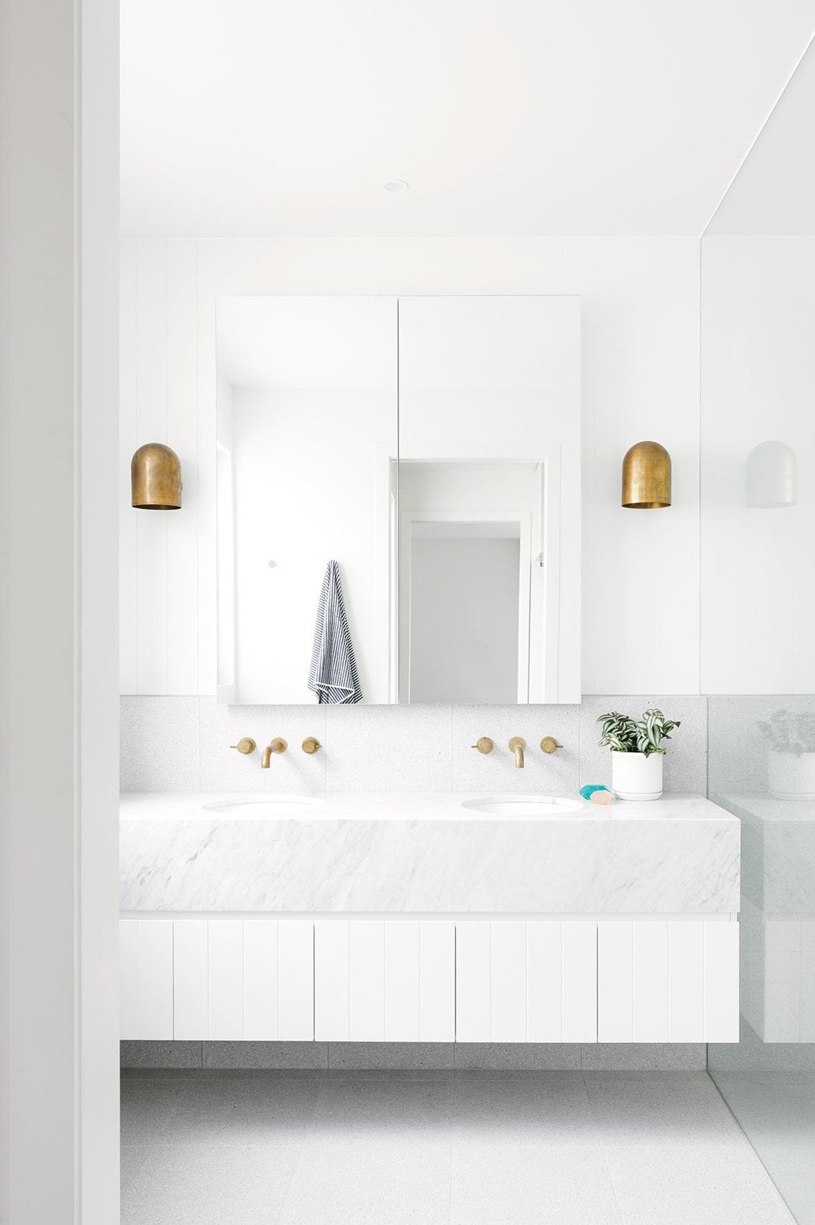 When creating an all-white bathroom it is crucial to think about texture. This bathroom in a [contemporary Geelong home](https://www.homestolove.com.au/this-contemporary-geelong-home-was-built-in-just-five-months-17561|target="_blank"), features a Carrara marble vanity and terrazzo flooring which stops the room feeling washed out.