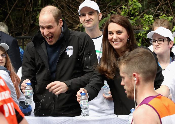 Making a splash: One cheeky runner splashed Prince William with water as he handed out refreshments.