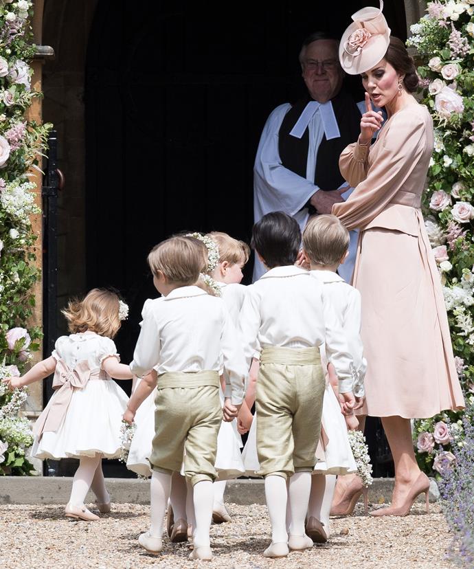 Kate leads the kids into the church while reminding them to keep quiet.