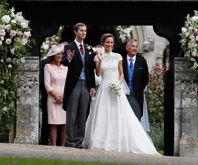 Flanked by her proud parents, Pippa waves to the crowd of well-wishers.