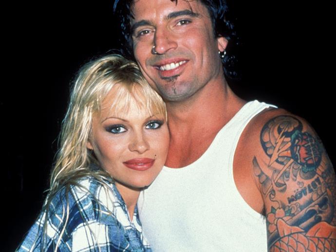 **1996:** Pamela met and wed Tommy Lee, drummer of band Mötley Crüe, early 1995 after knowing him for a mere four days. It was a rocky relationship that would last just three years, during which time they would welcome two sons - Brandon and Dylan. However these happier moments were marred by that infamous stolen sex tape, allegations of drug abuse and domestic violence. It was also during this tumultuous time that Pam would get her iconic barbed wire arm tattoo, something she'd later regret and remove.