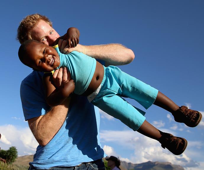 Harry swings around a little boy called Lerato during a visit to an orphanage in Lesotho, Africa.