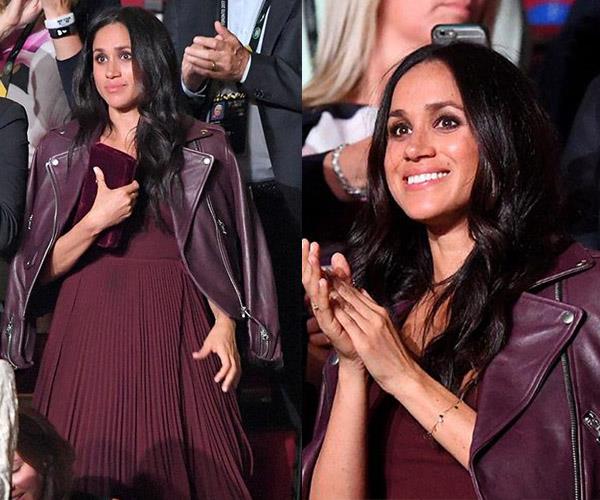 There was no denying that Meghan was having a ball cheering on her boyfriend Prince Harry as he opened his beloved **2017 Invictus Games** at the Air Canada Centre in Toronto. The glossy brunette stunned in a mulberry pleated dress and matching leather jacket by the brand **Mackage**. We have a feeling berry-hued leather jackets are about to become *very* popular.