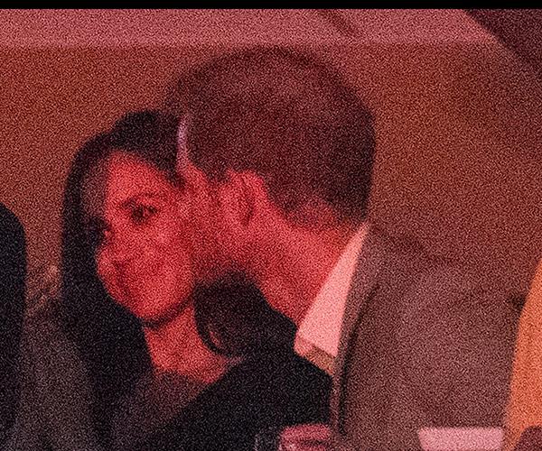 Prince Harry plants a kiss on Meghan Markle's cheek as they watch Bruce Springsteen and Bryan Adams perform at the Invictus Games closing ceremony.