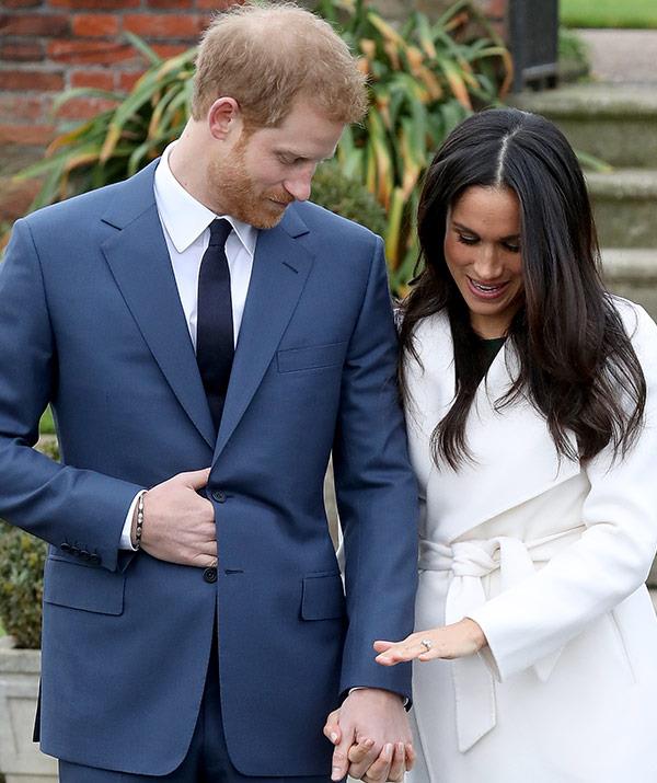 Meghan takes a moment to show off her engagement ring, which Prince Harry designed.