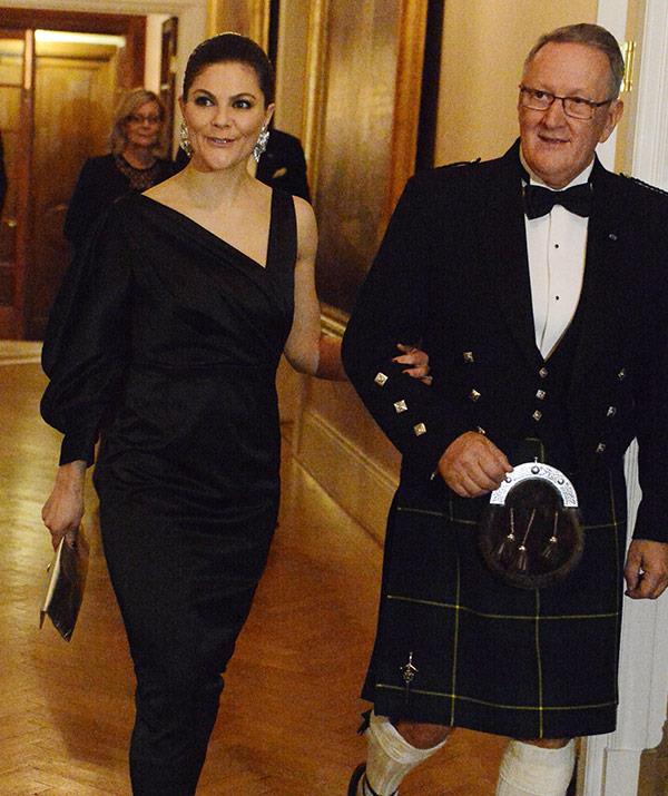 Princess Victoria opted for a black satin frock with a ruffled sleeve.