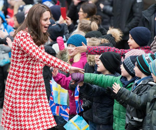Kate, who is six months pregnant with her third child, doled out the handshakes...