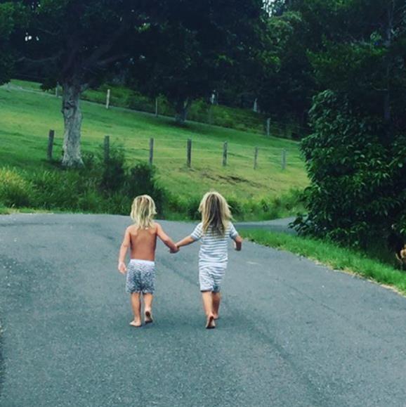 They're inseparable! The adoring mum captured this too-cute moment of her sunny-haired twins Sasha and Tristan holding hands as they head off on an adventure together.