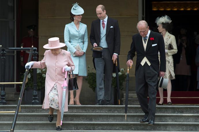Queen Elizabeth II and Prince Phillip, Princess Anne, Duchess Catherine and Prince William arrive at a garden party at Buckingham Palace in May 2017. Kate reached *way* back in her closet for this nearly five-year old pastel blue silk-satin coat dress which she paired with a hat by Lock & Co.