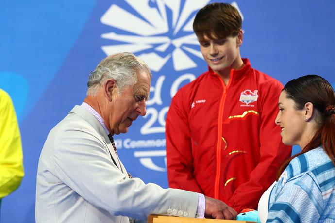 The Prince presenting medals to worthy swimming recipients at the Commonwealth Games.