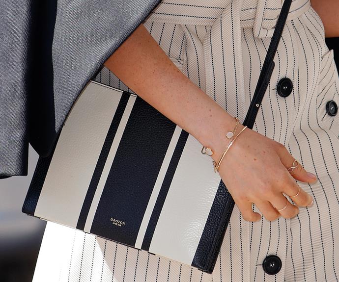 Meghan often totes a classic envelope style handbag. This one is buy Aussie label, Oroton.