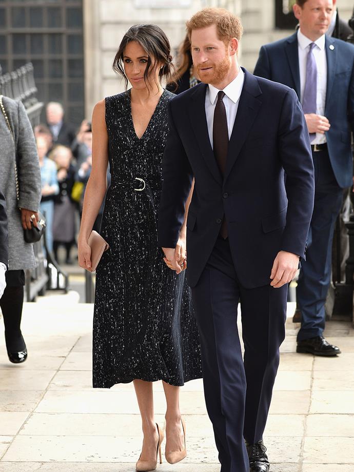 [Stepping out with Prince Harry](https://www.nowtolove.com.au/royals/british-royal-family/prince-harry-and-meghan-markle-first-appearance-since-royal-babys-birth-46742|target="_blank") to a memorial service to commemorate the 25th anniversary of the murder of Stephen Lawrence, Meghan wore a demure black Hugo Boss dress cinched in at the waist with a metallic buckle. She paired the chic ensemble with nude heels and a matching clutch. 