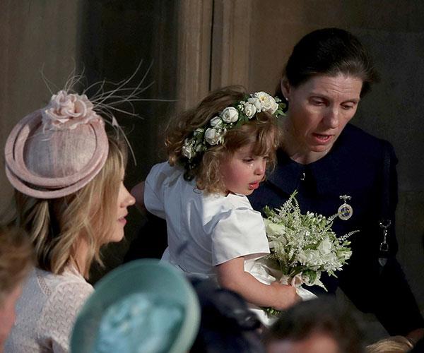 The "child whisperer" in action, soothing bridesmaid Zalie Warren at Prince Harry and Meghan Markle's wedding.