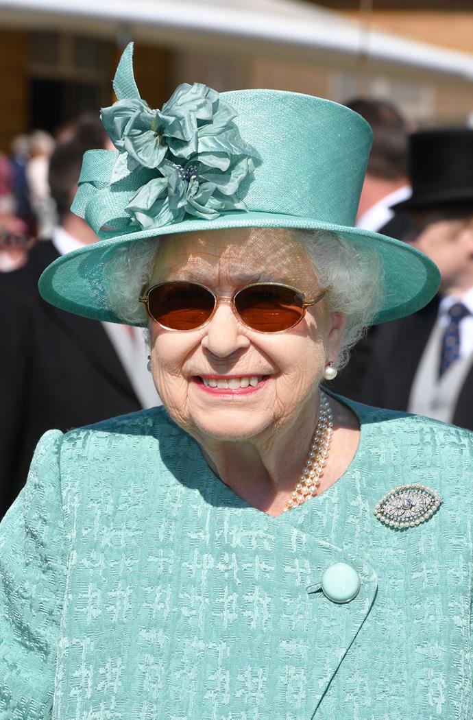 Always prepared, the Queen teamed her sunglasses with an umbrella - because you never know how the London weather will turn out for a Buckingham Palace garden party!