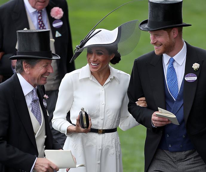 They're so happy! Meghan and Harry talk with the Queen's Bloodstock and Racing Advisor, John Warren.