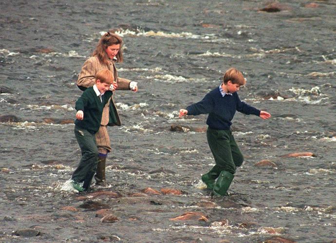 Royal Nanny, Tiggy Legge-Bourke née Pettifer, Prince William, and Prince Harry walk in the River Gairn, near the Balmoral Estate on October 22, 1994.
