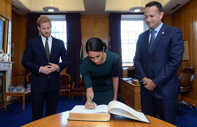 A former calligrapher, Meghan signs her name in the guest book.