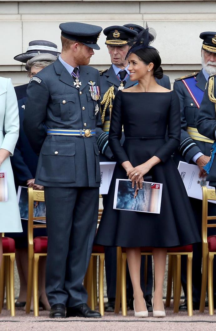 The Duchess of Sussex stunned in this black custom Dior dress at the RAF 100th anniversary celebrations. Meghan accessorised her favoured bateau neckline dress with a small black clutch and nude pumps, also by Dior, and a black fascinator by Stephen Jones. Simply divine!