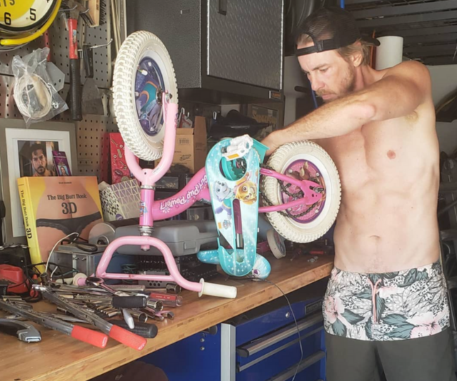 Hands on Dax doesn't palm off the dad jobs. Bell snapped a pic of her husband hard at work on one of his daughter's bikes, captioning it with, "The #dadbeast likes big butt books and fixin kids toyz." Wondering about the book? Zoom in and check out the bench. *Image: Instagram/KristenAnnieBell*