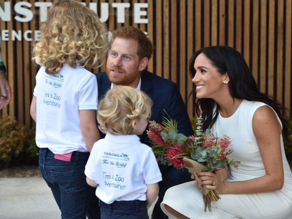Harry and Meghan have a renowned rapport with the public who flock to meet them, including the children like Findlay (right) and Dasha. (Image: Getty Images)