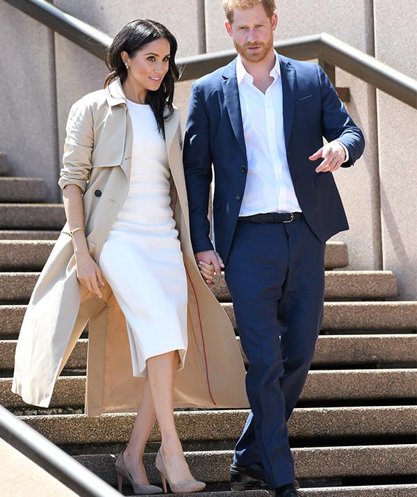 The weather was beautifully sunny for the first day of their Australian tour, but we can't blame the Duchess for covering up in this gorgeous camel overcoat - that wind was nippy! *(Image: Getty Images)*