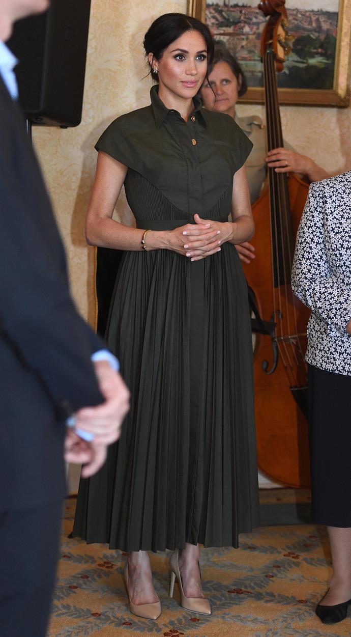 During an event at Admiralty House on Tuesday afternoon, Meghan wore this khaki green shirt dress by US designer Brandon Maxwell. *(Image: Getty Images)*