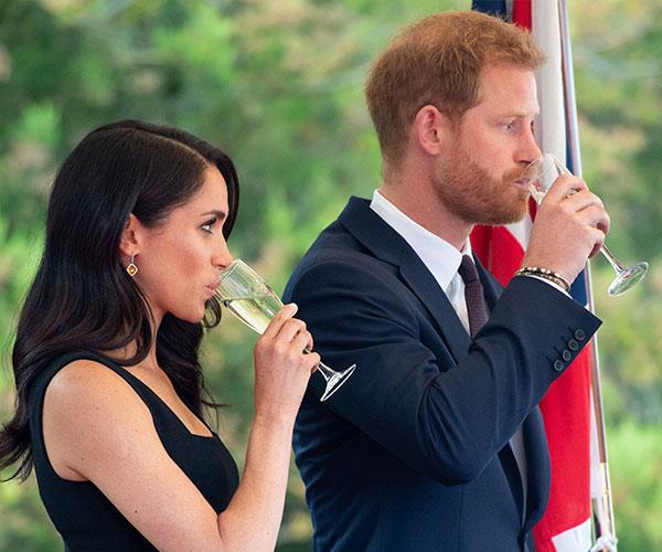 The last hurrah! Meghan and Harry were last seen with a drink in hand back in July. *(Image: Getty Images)*