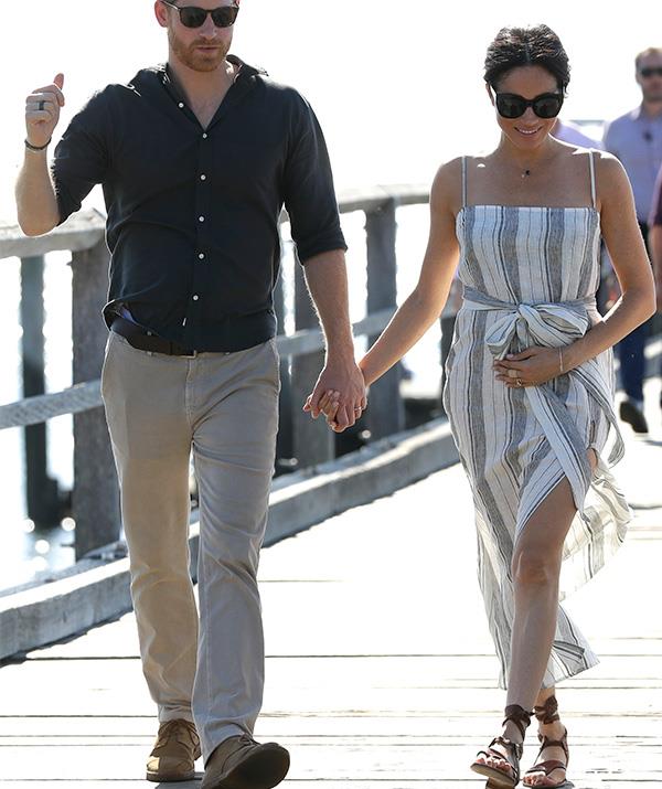 Baby bump alert! The floaty dress complimented Meghan's growing tummy. *(Image: Getty Images)*