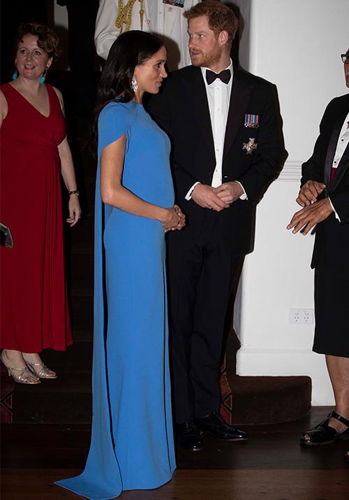 The royal couple stepped out looking classy as ever for an evening Soiree held by the Fijian Prime Minister. Meghan wore a striking blue SAFiYAA 'Ginkgo' cape gown for the event.