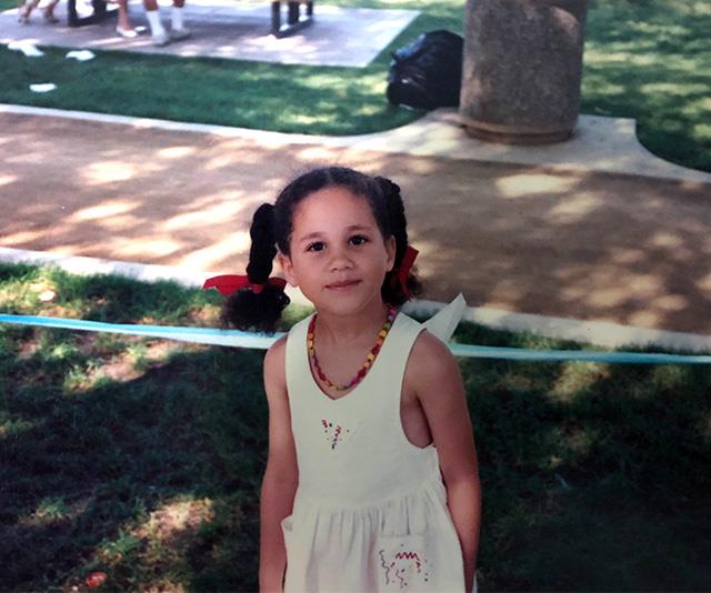 Meghan might be a style icon to the masses now, but she was setting trends even as a young tot. Her rainbow necklace and plaits finished with bow ties in this picture are the image of cute.