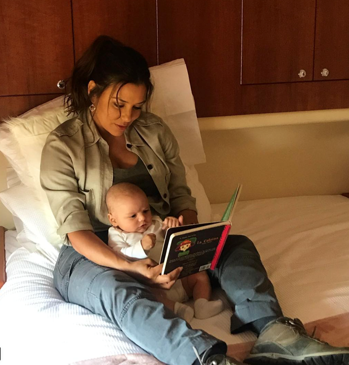 Eva takes time out on set to read to little Santiago who looks pretty involved with story time! Look at that concentration!