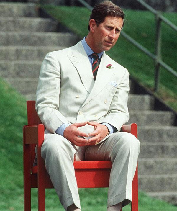 Clean tailoring, beige tones, a crisp blue shirt and a green and a red striped tie was a winning combo for the father-of-two during a garden party in 1994. *(Images: Getty)*