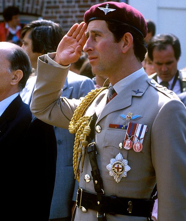 Charles shows a sign of salute during a visit to Bruneval in Normandy, France, to officially open a war memorial in 1982. *(Image: Getty)*
