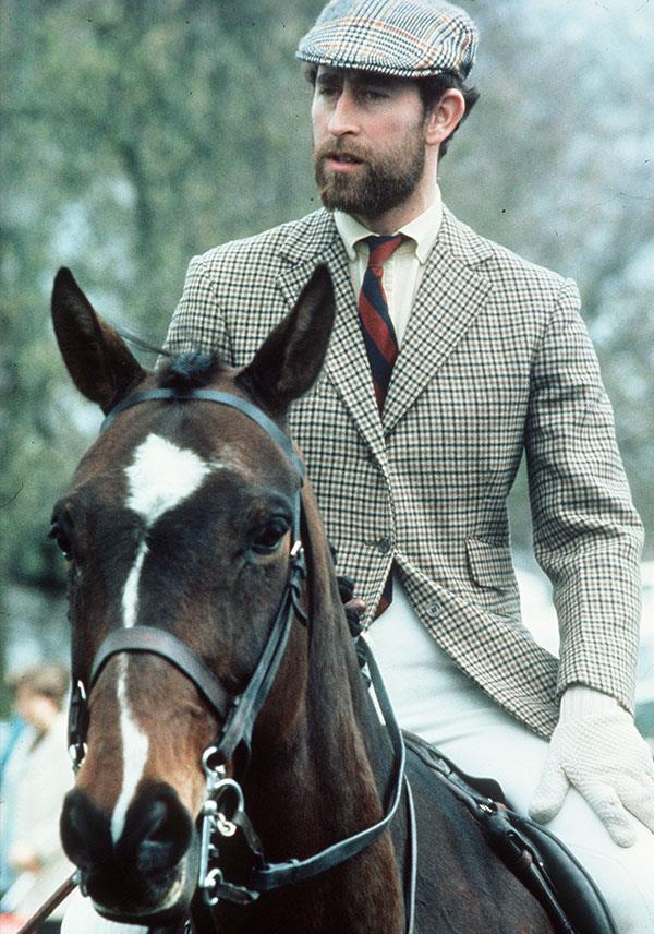 It's a little known fact but Charles sported a smart naval beard in the 70s. Here, the royal rides horseback dressed in traditional tweeds. *(Image: Getty)*