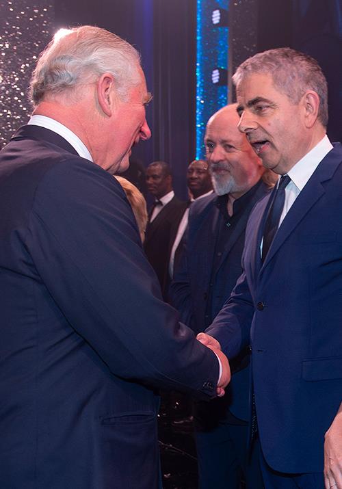 Rowan Atkinson was quick to joke with the Prince during their brief encounter. *(Image: AAP)*