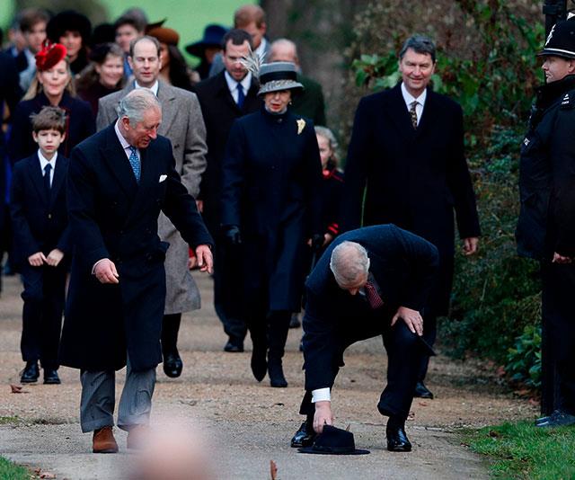 Whoops! Prince Andrew's hat topples off and older brother Prince Charles finds it most amusing.