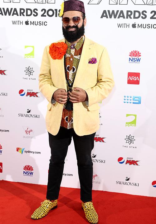 Between the leopard print shoes and the giant orange flower, we don't know which bit of  Joseph Tawadros' outfit to look at first!
