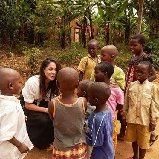 Meghan meeting local children as part of her World Vision trip to Rwanda.