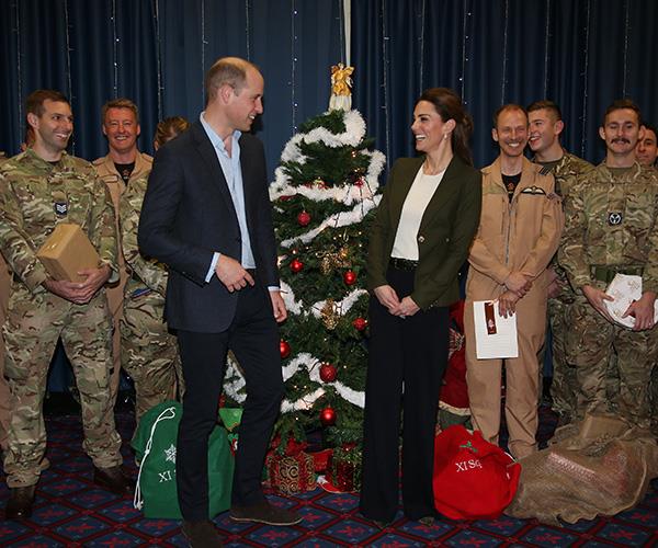 The Duke and Duchess joked as they handed out presents to serving personnel. *(Image: Getty Images)*