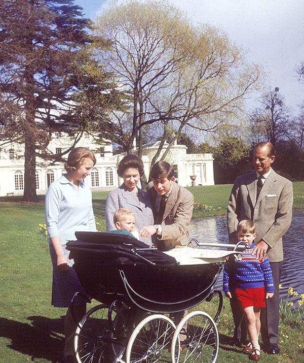Queen Elizabeth and her family push one-year-old Prince Edward around Frogmore House in 1965. *(Image: Historia/REX/Shutterstock)*