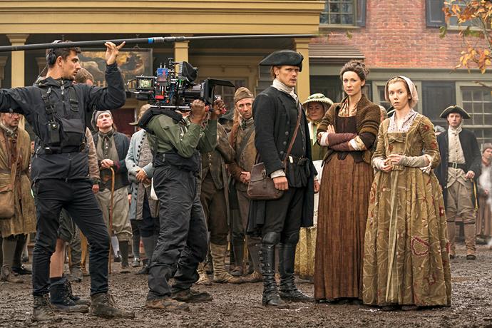 A behind the scenes look at Sam and Caitriona filming a scene.
