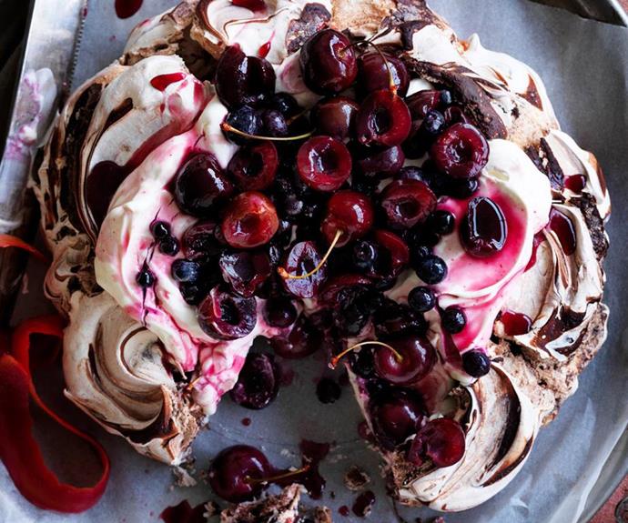 **Chocolate cherry berry pavlova**
<br><br>
This decadent chocolate, cherries and mixed berry pavlova is the perfect way to end a summertime get-together. 
<br><br>
See the full *Australian Women's Weekly* recipe [here](https://www.womensweeklyfood.com.au/recipes/chocolate-cherry-berry-pavlova-28516|target="_blank").