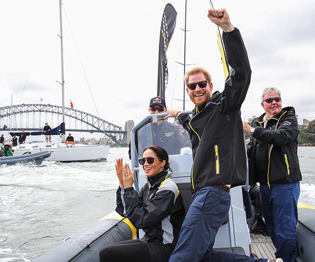 During the Invictus Games, Meghan and Harry set sail on Sydney Harbour, where Chris captured a special moment where the pair cheered on competitors. *(Image: Chris Jackson / Getty Images)*