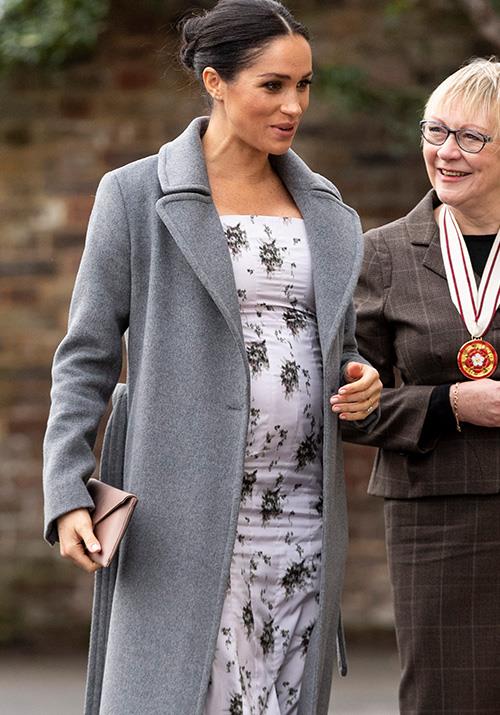 Meghan's growing bump was on full display as she visited a nursing home in London. *(Image: Getty)*